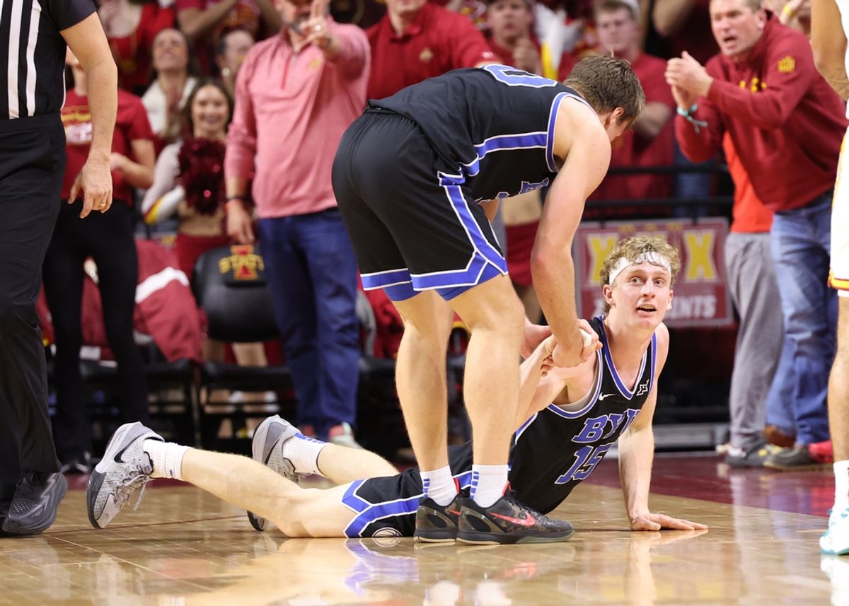 Mar 4, 2025; Ames, Iowa, USA; Brigham Young Cougars guard Dallin Hall (30) helps Brigham Young Cougars forward Richie Saunders (15) off the floor in their game with the Iowa State Cyclones during the second half at James H. Hilton Coliseum. Mandatory Credit: Reese Strickland-Imagn Images