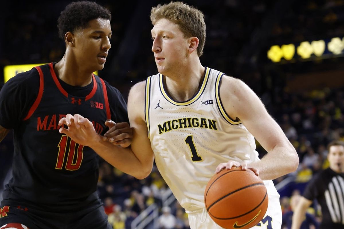 Mar 5, 2025; Ann Arbor, Michigan, USA;  Michigan Wolverines center Danny Wolf (1) is defended by Maryland Terrapins forward Julian Reese (10) in the first half at Crisler Center. Mandatory Credit: Rick Osentoski-Imagn Images