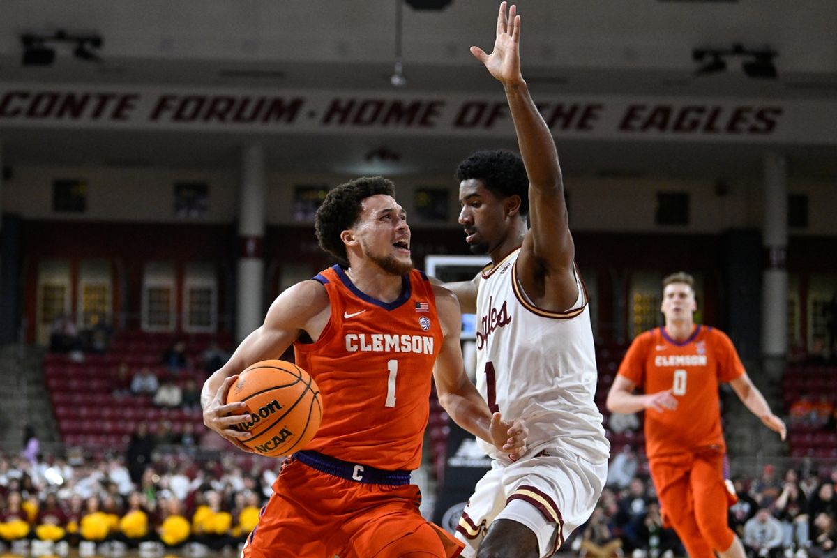 Mar 5, 2025; Chestnut Hill, Massachusetts, USA; Clemson Tigers guard Chase Hunter (1)  shoots against Boston College Eagles guard Dion Brown (1) during the first half at Conte Forum. Mandatory Credit: Eric Canha-Imagn Images