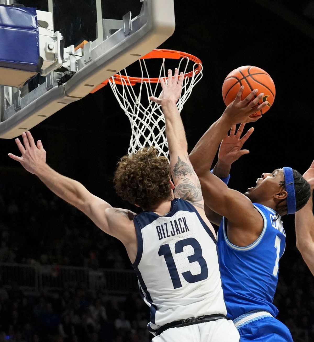 Butler Bulldogs guard Finley Bizjack (13) guards Xavier Musketeers guard Ryan Conwell (7) as he shoots the ball during the first half of a game Wednesday, March 5, 2025, at Hinkle Fieldhouse in Indianapolis.