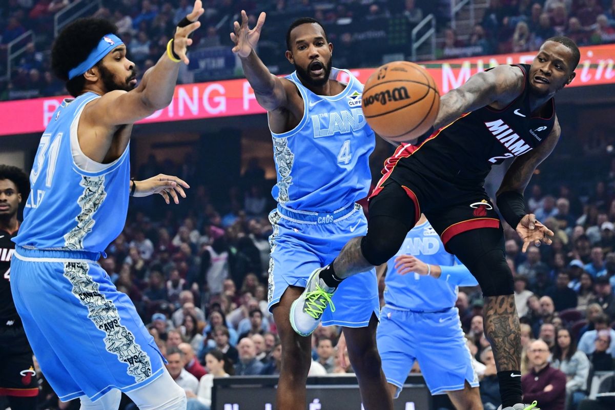 Mar 5, 2025; Cleveland, Ohio, USA; Miami Heat guard Terry Rozier (2) passes as Cleveland Cavaliers center Jarrett Allen (31) and forward Evan Mobley (4) defend during the first half at Rocket Arena. Mandatory Credit: Ken Blaze-Imagn Images