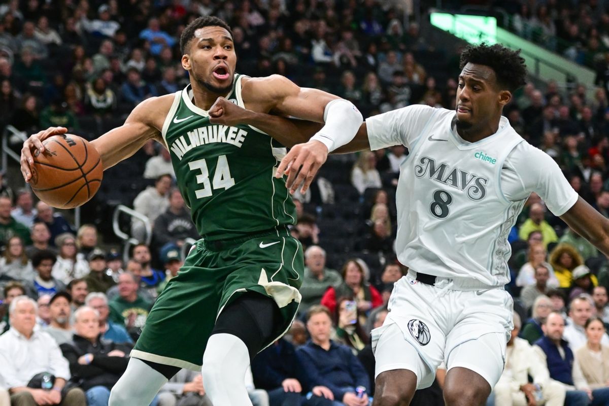 Mar 5, 2025; Milwaukee, Wisconsin, USA; Milwaukee Bucks forward Giannis Antetokounmpo (34) drives for the basket against Dallas Mavericks forward Olivier-Maxence Prosper (8) in the second quarter at Fiserv Forum. Mandatory Credit: Benny Sieu-Imagn Images