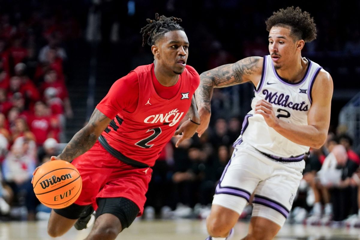 Cincinnati Bearcats guard Jizzle James (2) attempts to drive past Kansas State Wildcats guard Max Jones (2) in the first half of a NCAA men’s basketball game between the Cincinnati Bearcats and Kansas State Wildcats, Wednesday, March 5, 2025, at Fifth Third Arena in Cincinnati.