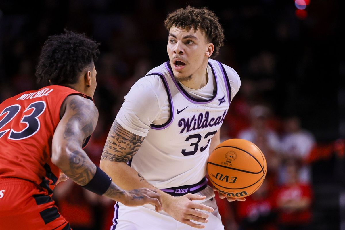 Mar 5, 2025; Cincinnati, Ohio, USA; Kansas State Wildcats guard Coleman Hawkins (33) holds the ball against Cincinnati Bearcats forward Dillon Mitchell (23) in the second half at Fifth Third Arena. Mandatory Credit: Katie Stratman-Imagn Images