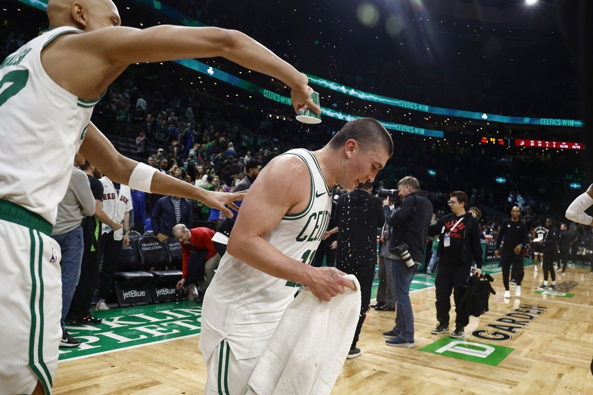 Mar 5, 2025; Boston, Massachusetts, USA; After scoring a career high 43 points, Boston Celtics guard Payton Pritchard (11) has water dumped on him by guard Jordan Walsh (27) after their win over the Portland Trail Blazers at TD Garden. Mandatory Credit: Winslow Townson-Imagn Images