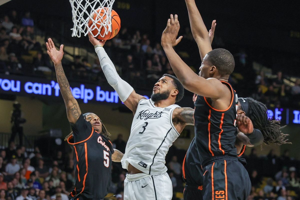 Mar 5, 2025; Orlando, Florida, USA; UCF Knights guard Darius Johnson (3) goes to the basket against Oklahoma State Cowboys guard Khalil Brantley (5) during the second half at Addition Financial Arena. Mandatory Credit: Mike Watters-Imagn Images