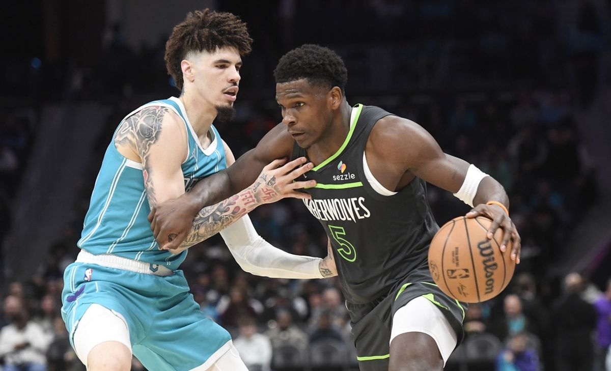 Mar 5, 2025; Charlotte, North Carolina, USA;  Minnesota Timberwolves guard Anthony Edwards (5) drives past Charlotte Hornets guard LaMelo Ball (1) during the second half at the Spectrum Center. Mandatory Credit: Sam Sharpe-Imagn Images