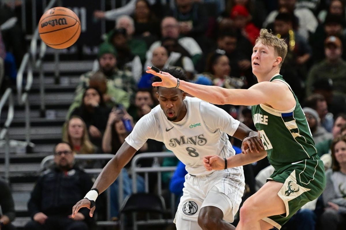 Mar 5, 2025; Milwaukee, Wisconsin, USA; Milwaukee Bucks guard AJ Green (20) gets a pass away from Dallas Mavericks forward Olivier-Maxence Prosper (8) in the third quarter at Fiserv Forum. Mandatory Credit: Benny Sieu-Imagn Images