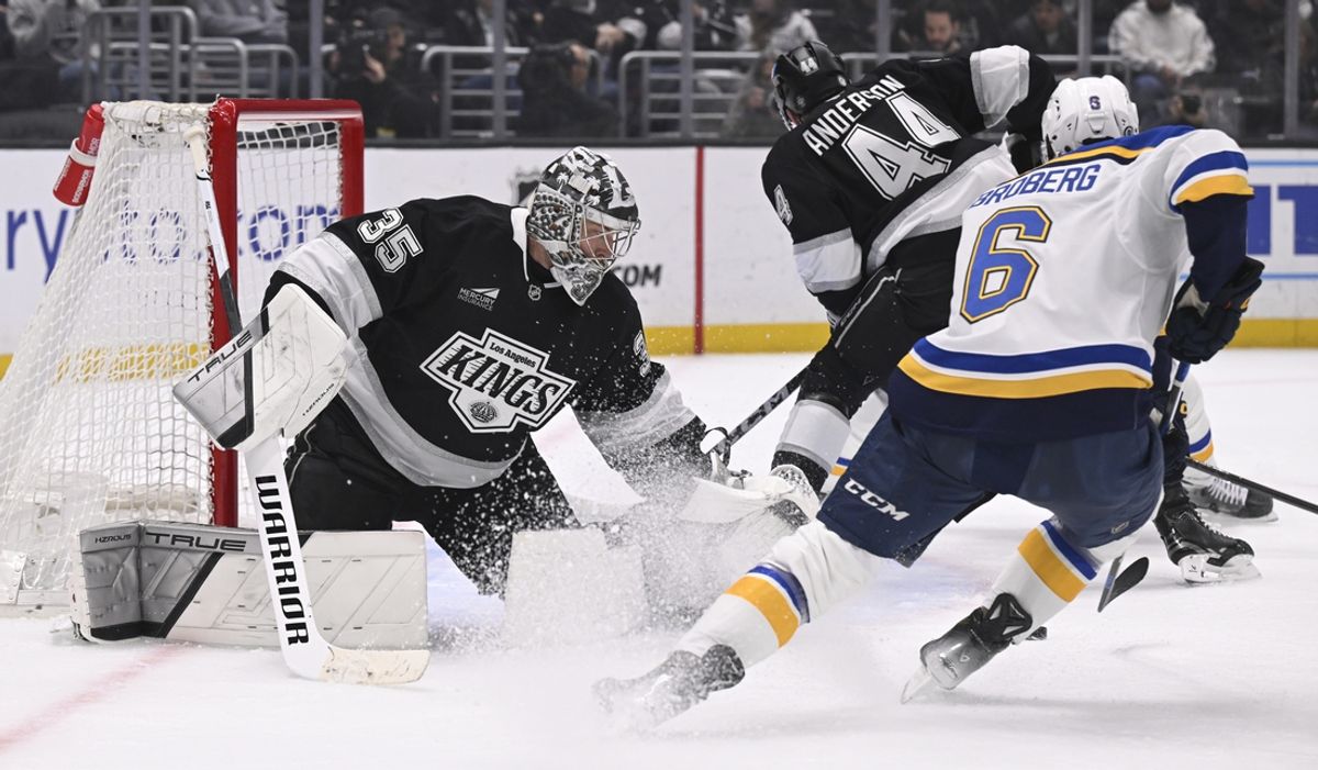 Mar 5, 2025; Los Angeles, California, USA;  Los Angeles Kings goaltender Darcy Kuemper (35) blocks a shot by St. Louis Blues defenseman Philip Broberg (6) during the first period at Crypto.com Arena. Mandatory Credit: Alex Gallardo-Imagn Images