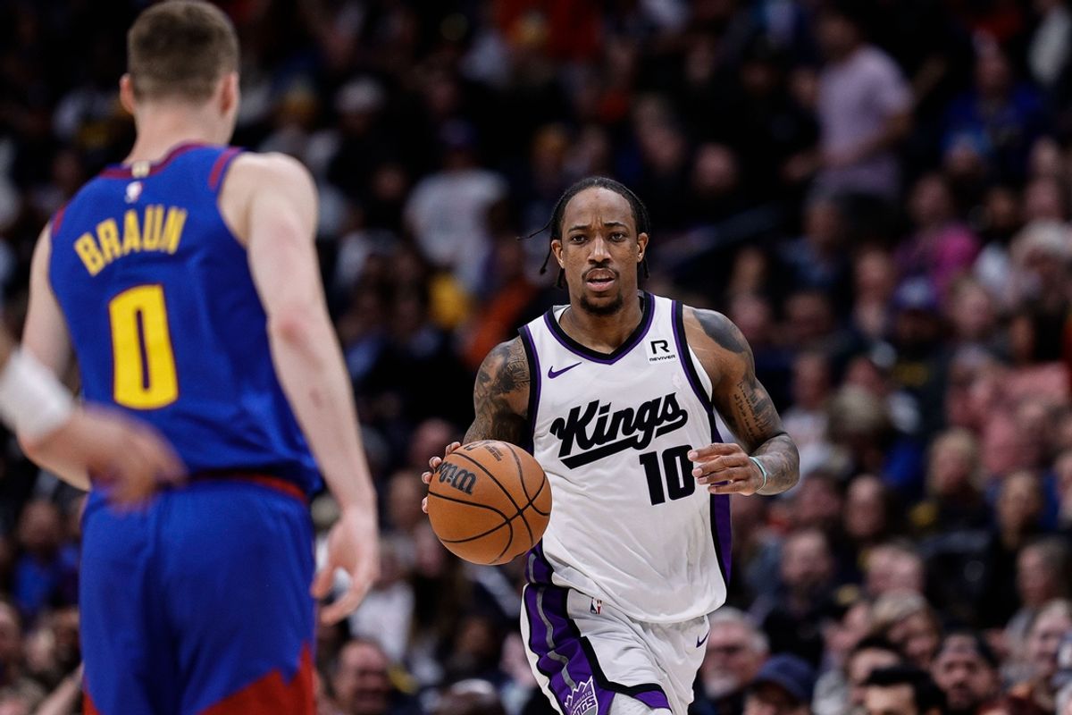 Mar 5, 2025; Denver, Colorado, USA; Sacramento Kings forward DeMar DeRozan (10) controls the ball as Denver Nuggets guard Christian Braun (0) guards in the fourth quarter at Ball Arena. Mandatory Credit: Isaiah J. Downing-Imagn Images
