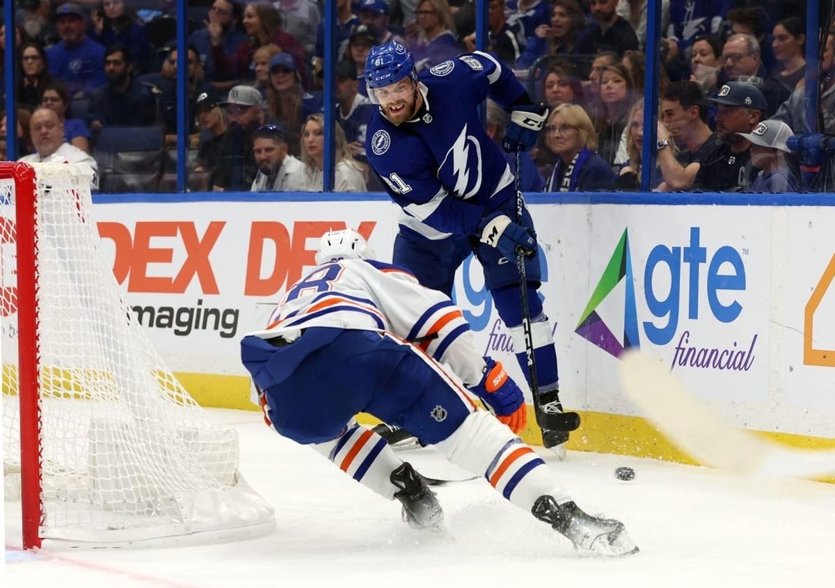 Nov 18, 2023; Tampa, Florida, USA; Tampa Bay Lightning defenseman Erik Cernak (81) passes the puck s Edmonton Oilers right wing Connor Brown (28) defends during the second period at Amalie Arena.