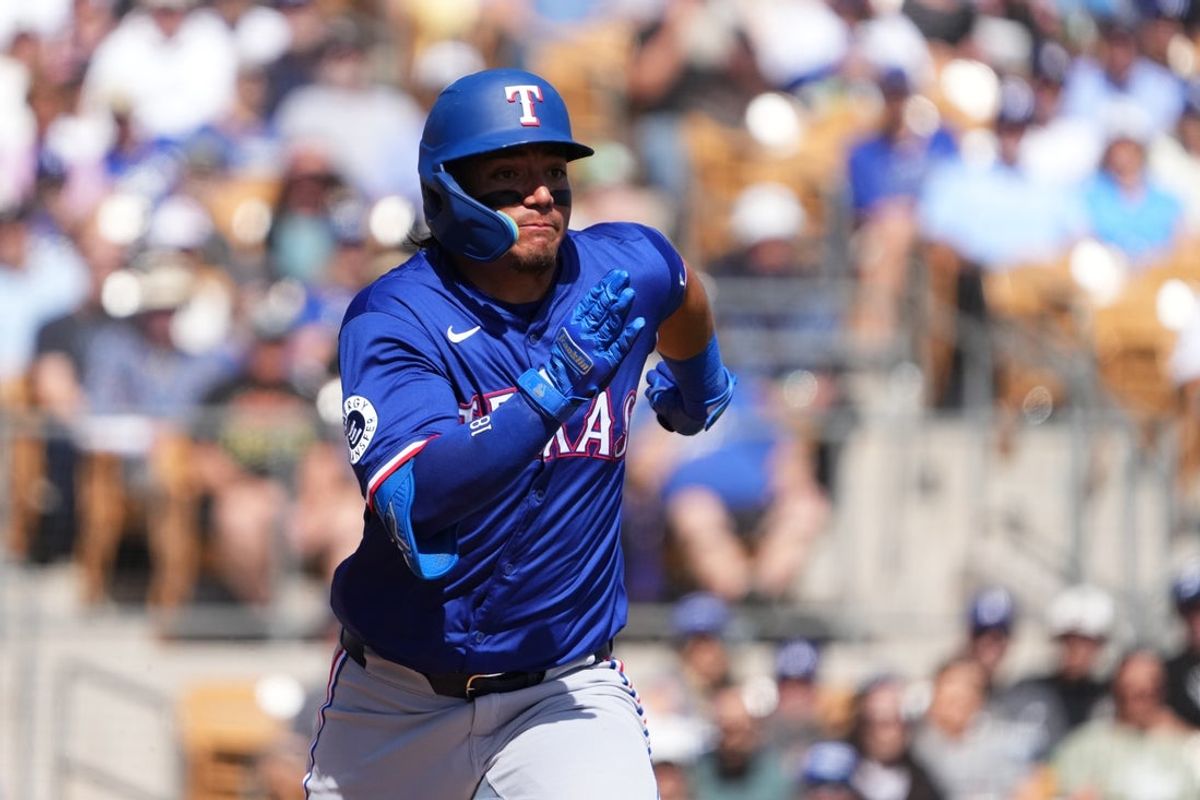 Mar 6, 2025; Phoenix, Arizona, USA; Texas Rangers left fielder Alejandro Osuna (76) runs to first base during an at bat against the Los Angeles Dodgers during the second inning at Camelback Ranch-Glendale. Mandatory Credit: Joe Camporeale-Imagn Images