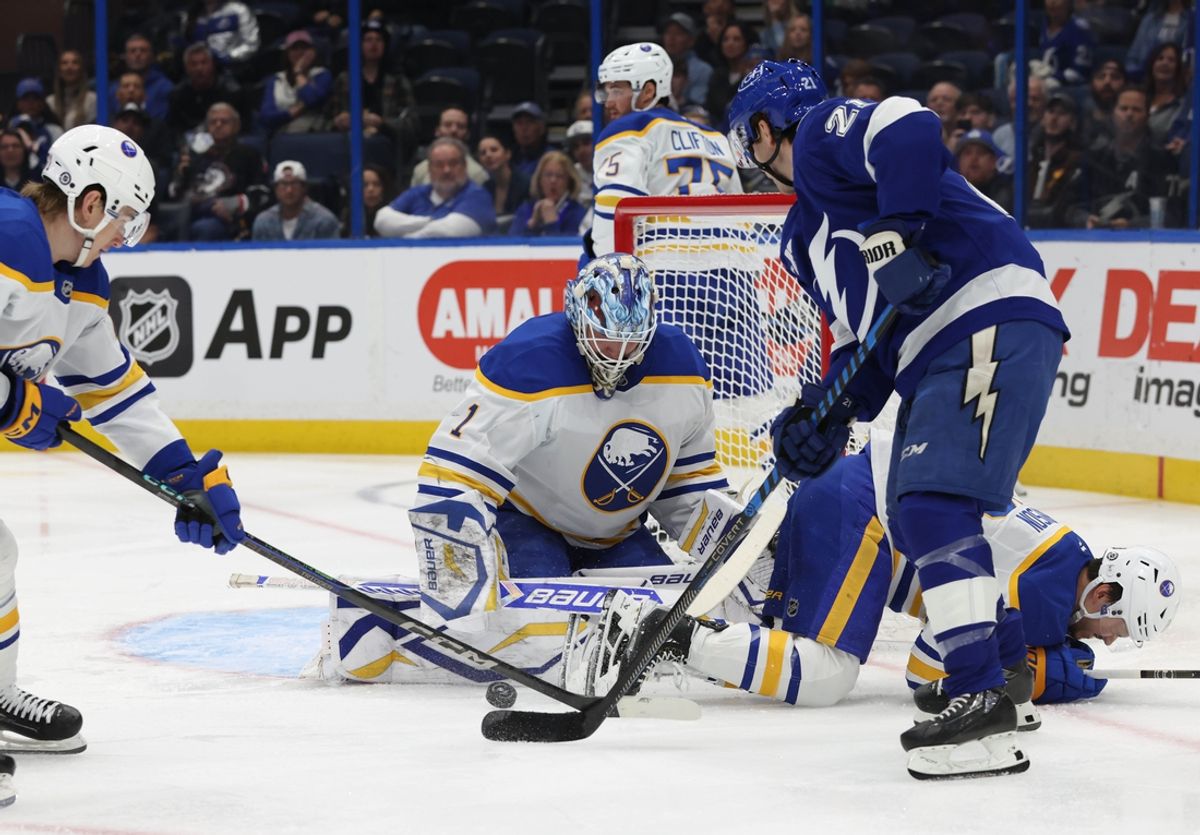 Mar 6, 2025; Tampa, Florida, USA; Buffalo Sabres goaltender Ukko-Pekka Luukkonen (1) and center Ryan McLeod (71) defend the puck from Tampa Bay Lightning center Brayden Point (21) during the first period at Amalie Arena. Mandatory Credit: Kim Klement Neitzel-Imagn Images