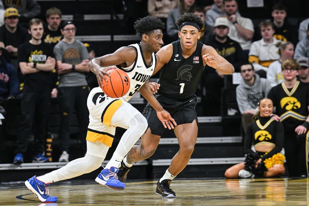 Mar 6, 2025; Iowa City, Iowa, USA; Iowa Hawkeyes guard Drew Thelwell (3) controls the ball as Michigan State Spartans guard Jeremy Fears Jr. (1) defends during the first half at Carver-Hawkeye Arena. Mandatory Credit: Jeffrey Becker-Imagn Images