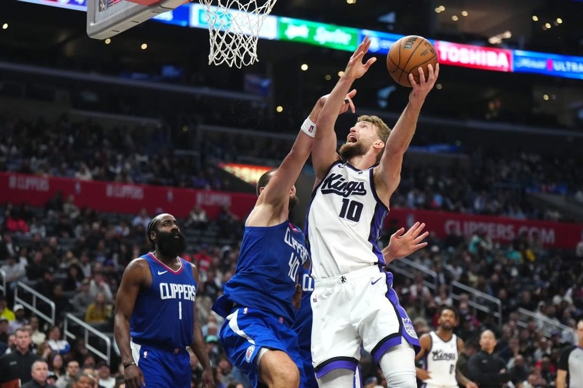 Dec 6, 2023; Los Angeles, California, USA; Sacramento Kings forward Domantas Sabonis (10) shoots the ball against LA Clippers center Ivica Zubac (40) in the second half at Crypto.com Arena.