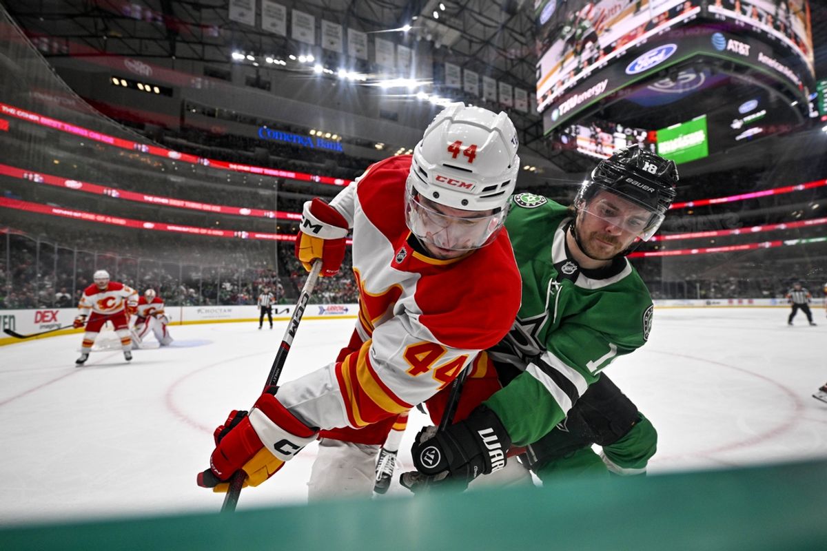 Mar 6, 2025; Dallas, Texas, USA; Calgary Flames defenseman Joel Hanley (44) and Dallas Stars center Sam Steel (18) battle for control of the puck during the second period at the American Airlines Center. Mandatory Credit: Jerome Miron-Imagn Images