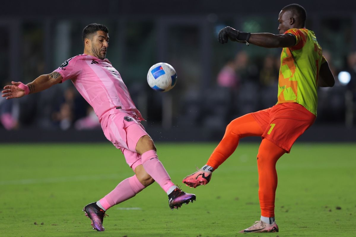 Mar 6, 2025; Ft. Lauderdale, Florida, USA; Inter Miami CF forward Luis Suarez (9) reaches for the ball against Cavalier FC goalkeeper Vino Barclett (1) during the second half at Chase Stadium. Mandatory Credit: Sam Navarro-Imagn Images