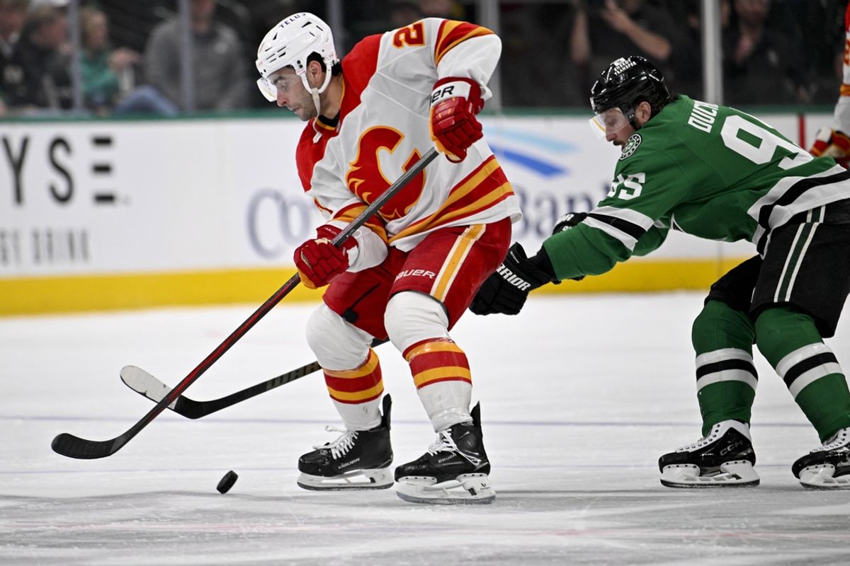 Mar 6, 2025; Dallas, Texas, USA; Calgary Flames right wing Matt Coronato (27) skates with the puck past Dallas Stars center Matt Duchene (95) during the third period at the American Airlines Center. Mandatory Credit: Jerome Miron-Imagn Images
