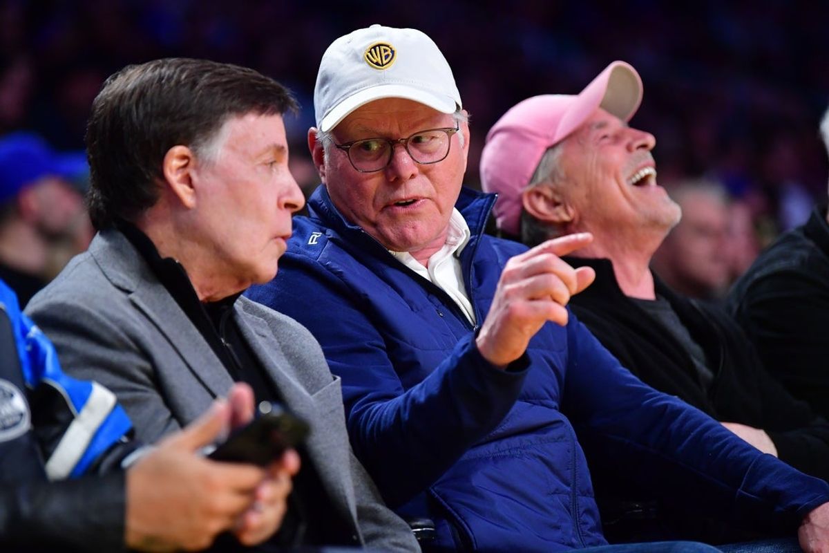 Mar 6, 2025; Los Angeles, California, USA; Network executive David Zaslav and Bob Costas attend the game between the Los Angeles Lakers and New York Knicks during the first half at Crypto.com Arena. Mandatory Credit: Gary A. Vasquez-Imagn Images
