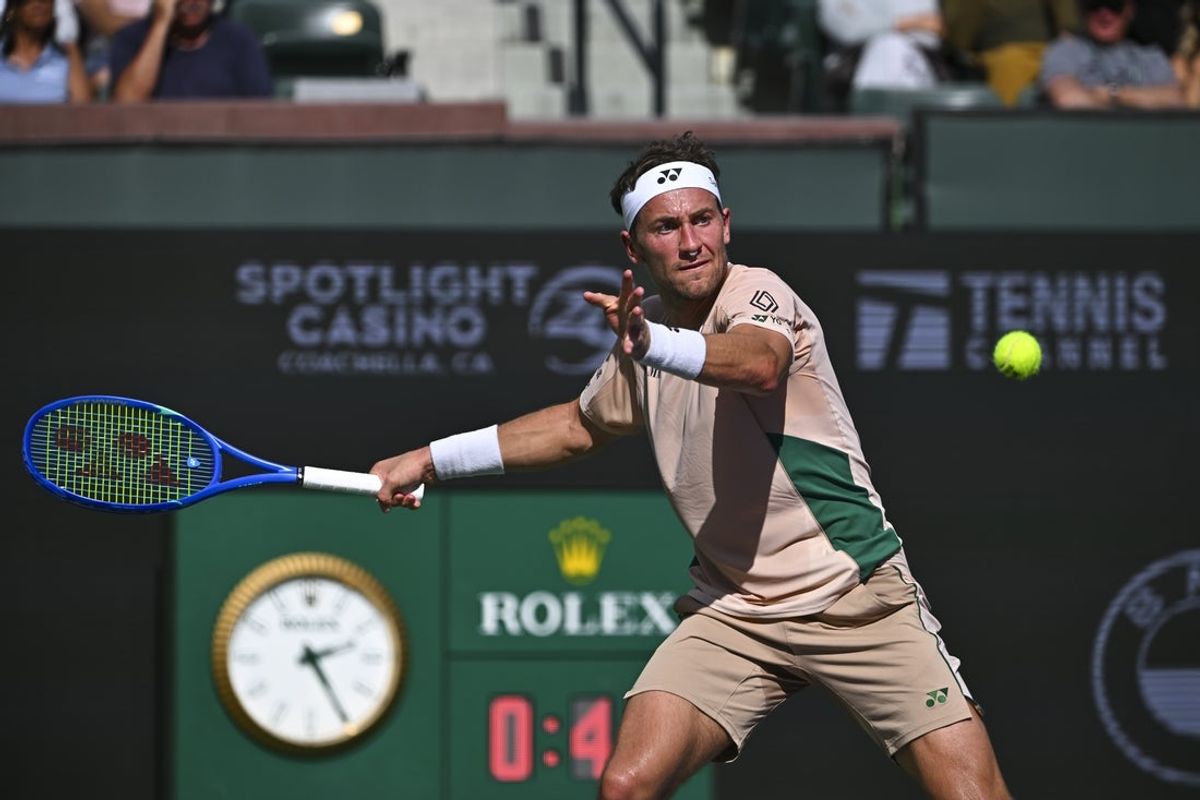 Mar 7, 2025; Indian Wells, CA, USA; Casper Ruud (NOR) hits a ball against Marcos Giron (USA) at Indian Well Tennis Garden. Mandatory Credit: Jonathan Hui-Imagn Images