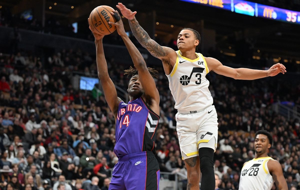 Mar 7, 2025; Toronto, Ontario, CAN;  Toronto Raptors guard Ja'Kobe Walter (14) grabs a rebound against Utah Jazz guard Keyonte George (3) in the first half at Scotiabank Arena. Mandatory Credit: Dan Hamilton-Imagn Images