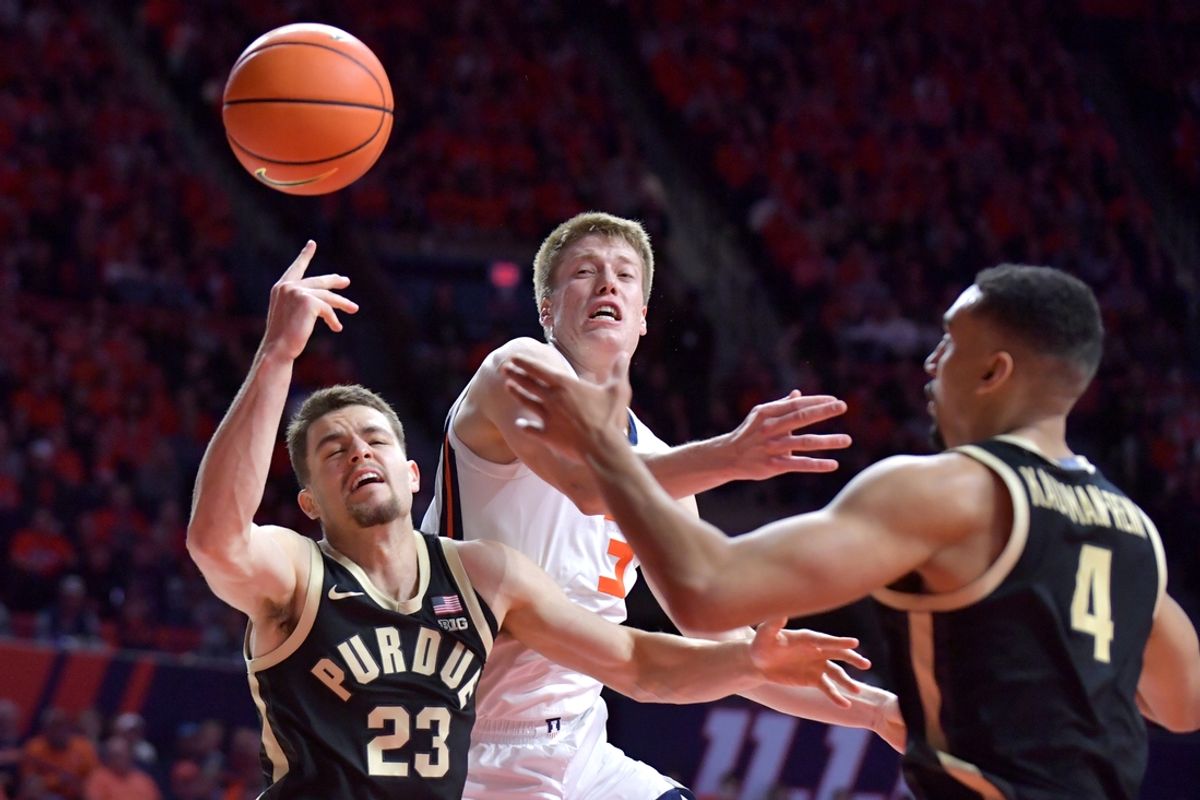 Mar 7, 2025; Champaign, Illinois, USA;  Purdue Boilermakers forward Camden Heide (23) and Trey Kaufman-Renn (4)try to pull a rebound away from Illinois Fighting Illini forward Ben Humrichous (3) during the first half at State Farm Center. Mandatory Credit: Ron Johnson-Imagn Images