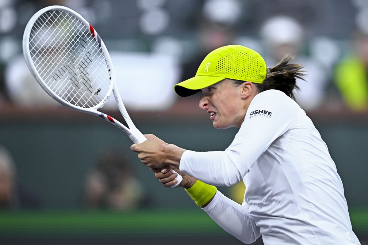 Mar 7, 2025; Indian Wells, CA, USA; Iga Swiatek (POL) hits a ball against Caroline Garcia (FRA) at Indian Well Tennis Garden. Mandatory Credit: Jonathan Hui-Imagn Images