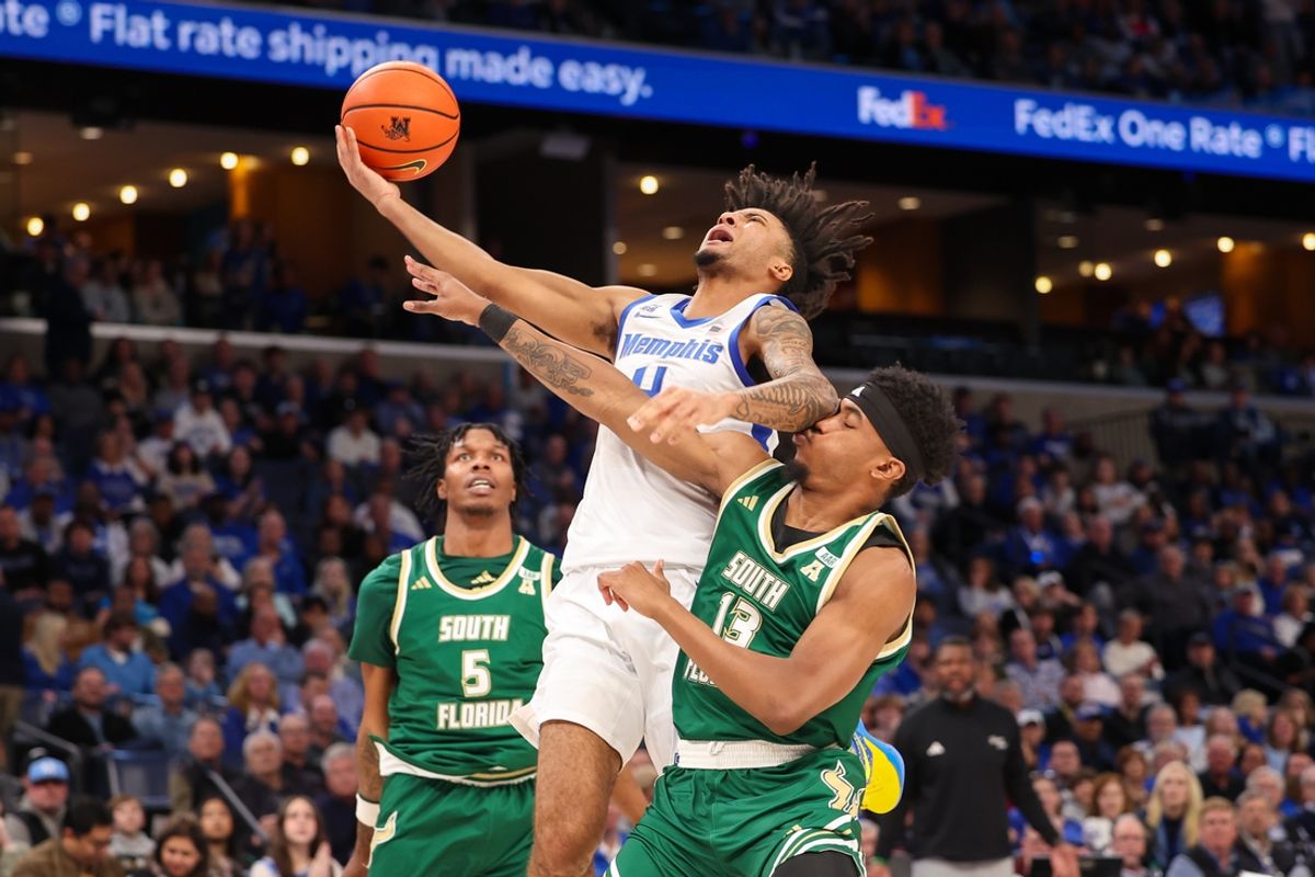 Mar 7, 2025; Memphis, Tennessee, USA; Memphis Tigers guard PJ Haggerty (4) shoots as South Florida Bulls guard Kasen Jennings (13) defends during the first half at FedExForum. Mandatory Credit: Wesley Hale-Imagn Images