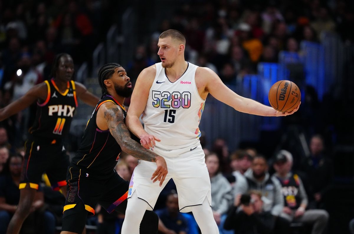Mar 7, 2025; Denver, Colorado, USA;  Phoenix Suns center Nick Richards (2) defends on Denver Nuggets center Nikola Jokic (15) in the first quarter at Ball Arena. Mandatory Credit: Ron Chenoy-Imagn Images