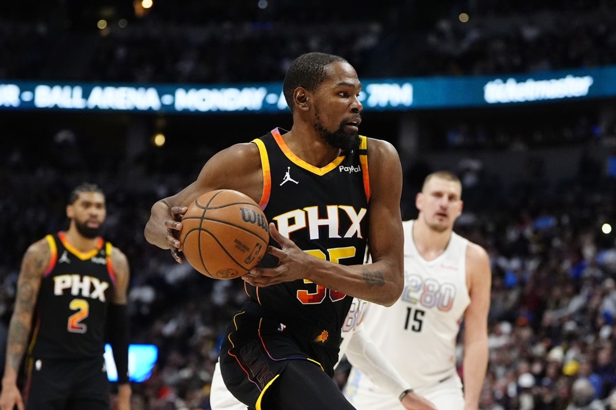 Mar 7, 2025; Denver, Colorado, USA; Phoenix Suns forward Kevin Durant (35) drives to the net in the second quarter against the Denver Nuggets at Ball Arena. Mandatory Credit: Ron Chenoy-Imagn Images