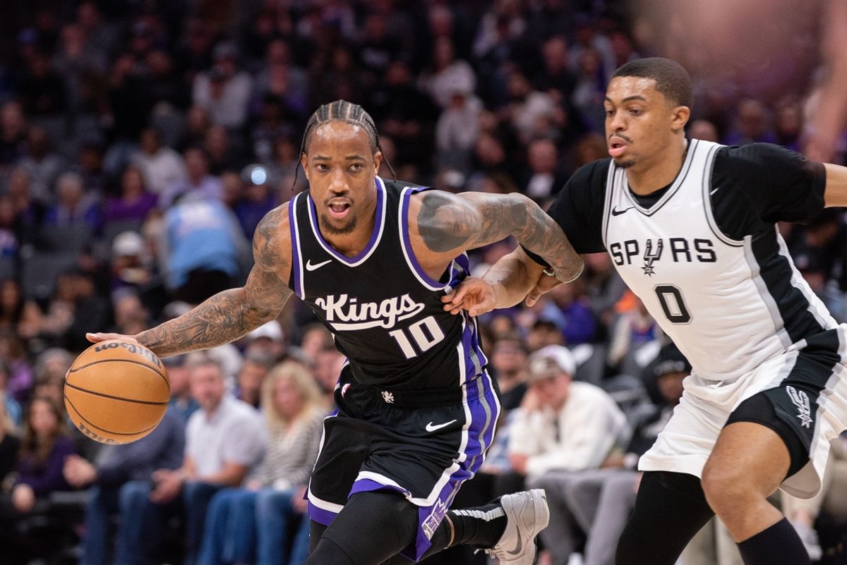 Mar 7, 2025; Sacramento, California, USA; Sacramento Kings forward DeMar DeRozan (10) drives to the basket against San Antonio Spurs forward Keldon Johnson (0) during the first quarter at Golden 1 Center. Mandatory Credit: Ed Szczepanski-Imagn Images