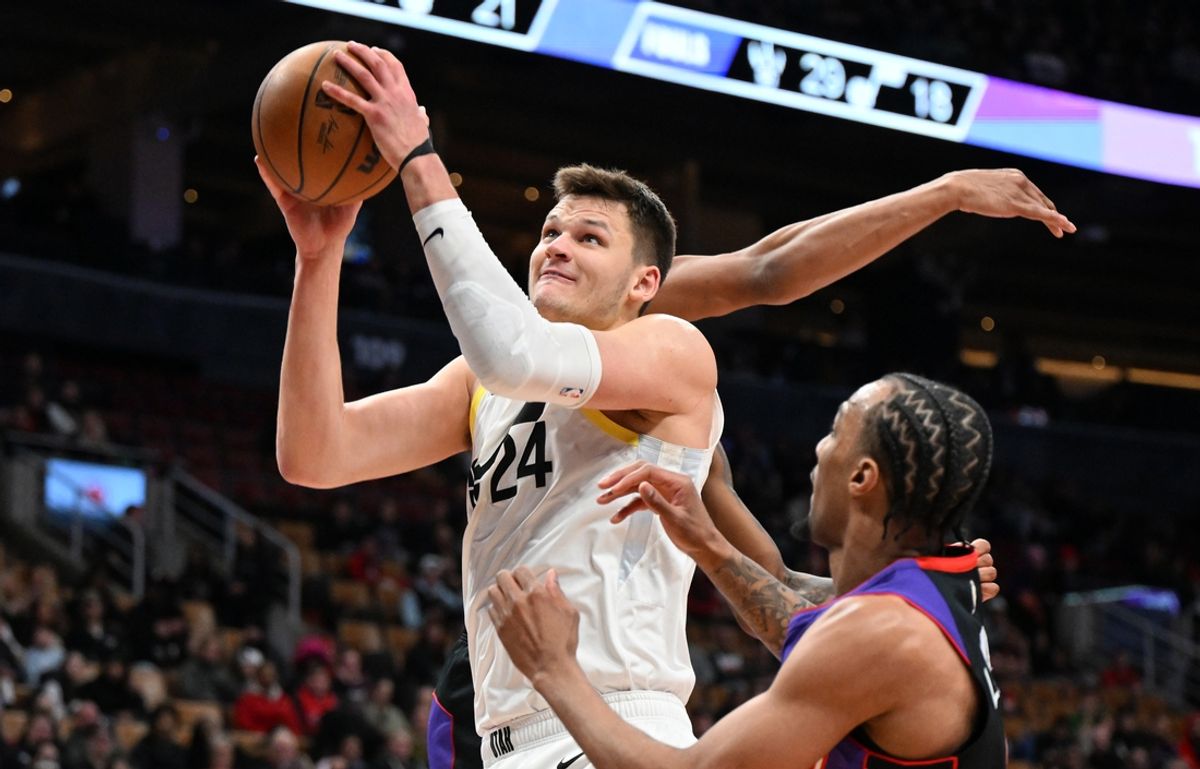 Mar 7, 2025; Toronto, Ontario, CAN;  Utah Jazz center Walker Kessler (24) goes in for a layup over Toronto Raptors guard AJ Lawson (0) in the second half at Scotiabank Arena. Mandatory Credit: Dan Hamilton-Imagn Images