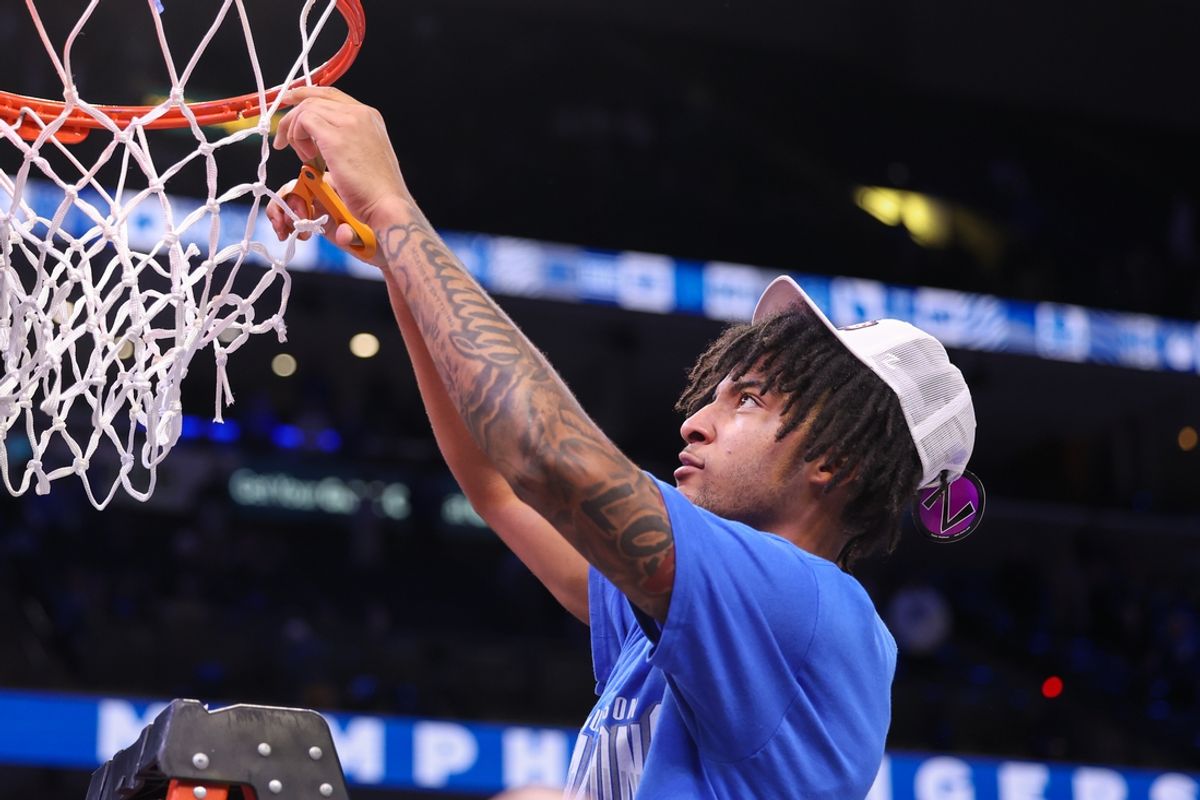 Mar 7, 2025; Memphis, Tennessee, USA; Memphis Tigers guard PJ Haggerty (4) cuts the net after winning the game against the South Florida Bulls at FedExForum. Mandatory Credit: Wesley Hale-Imagn Images