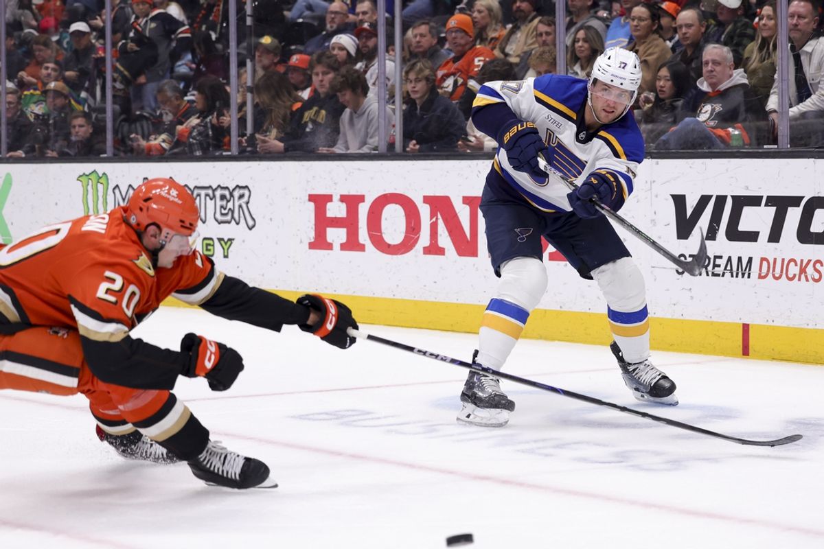 Mar 7, 2025; Anaheim, California, USA; St. Louis Blues defenseman Cam Fowler (17) moves the puck ahead of Anaheim Ducks right wing Brett Leason (20) during the second period at Honda Center. Mandatory Credit: Ryan Sun-Imagn Images
