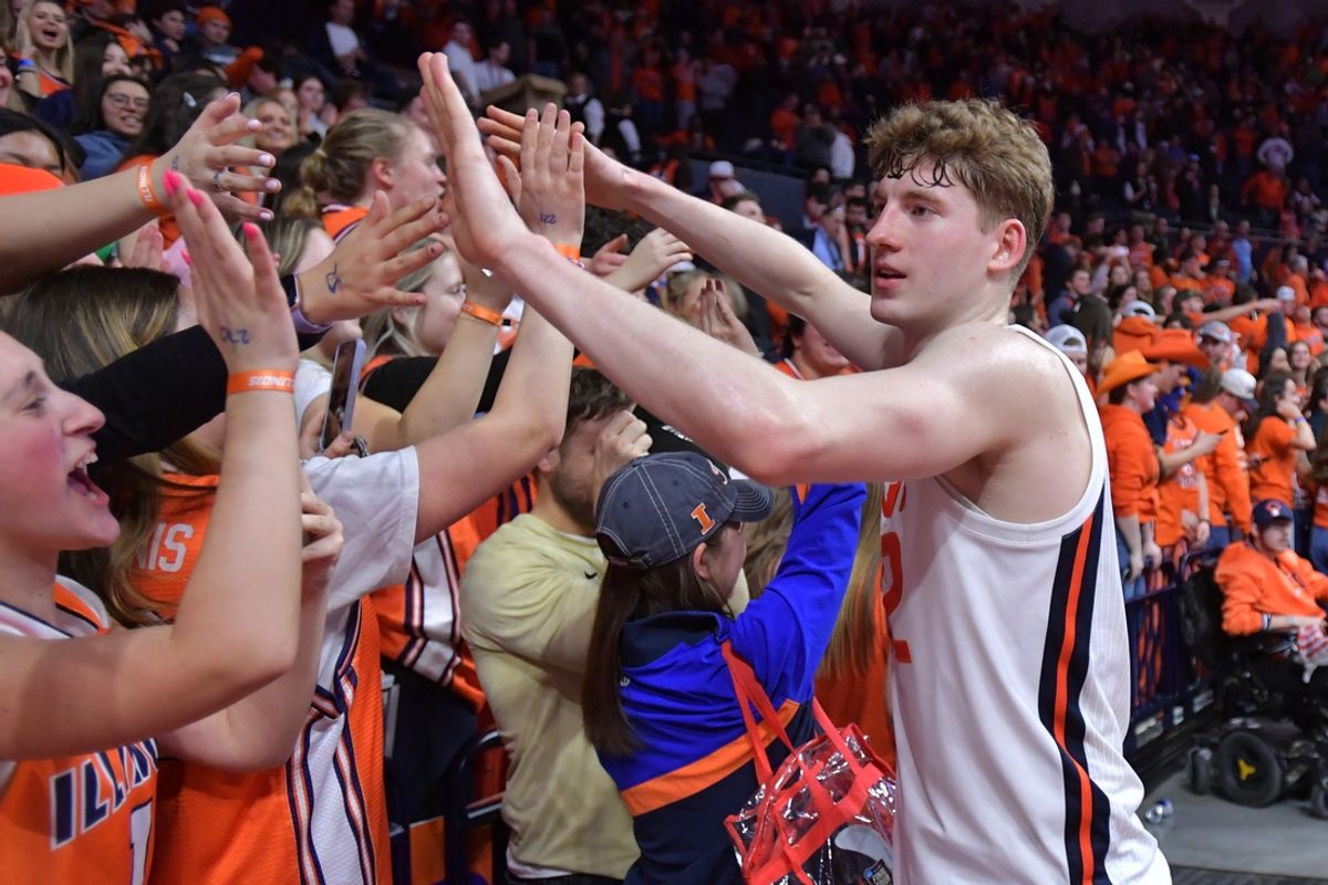 Mar 7, 2025; Champaign, Illinois, USA;  Illinois Fighting Illini guard Kasparas Jakucionis (32) gets a hand from the fans after a 88-80 win over the Purdue Boilermakers  at State Farm Center. Mandatory Credit: Ron Johnson-Imagn Images
