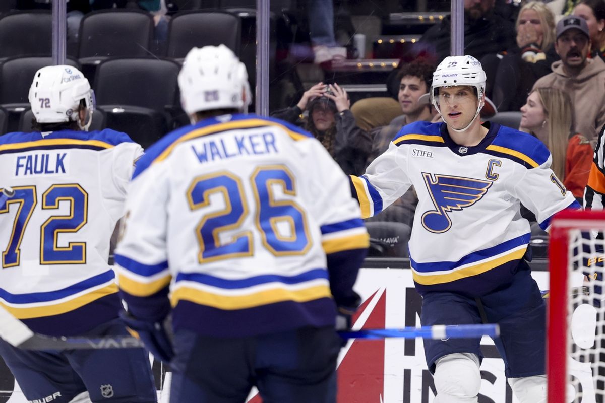 Mar 7, 2025; Anaheim, California, USA; St. Louis Blues center Brayden Schenn (10) celebrates his goal with defenseman Justin Faulk (72) and left wing Nathan Walker (26) against the Anaheim Ducks during the third period at Honda Center. Mandatory Credit: Ryan Sun-Imagn Images