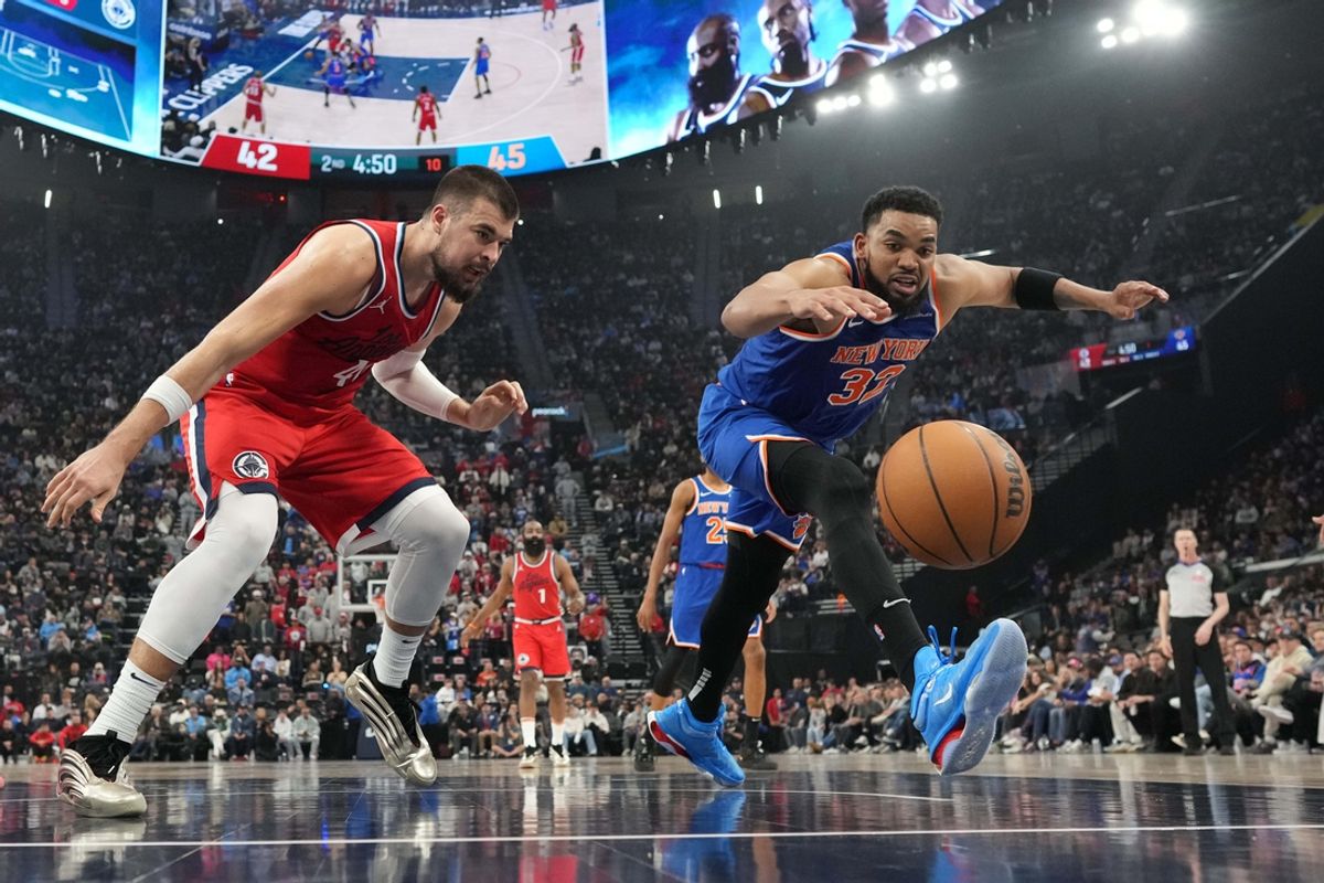 Mar 7, 2025; Inglewood, California, USA; New York Knicks center Karl-Anthony Towns (32) and LA Clippers center Ivica Zubac (40) reach for the ball in the first half at Intuit Dome. Mandatory Credit: Kirby Lee-Imagn Images