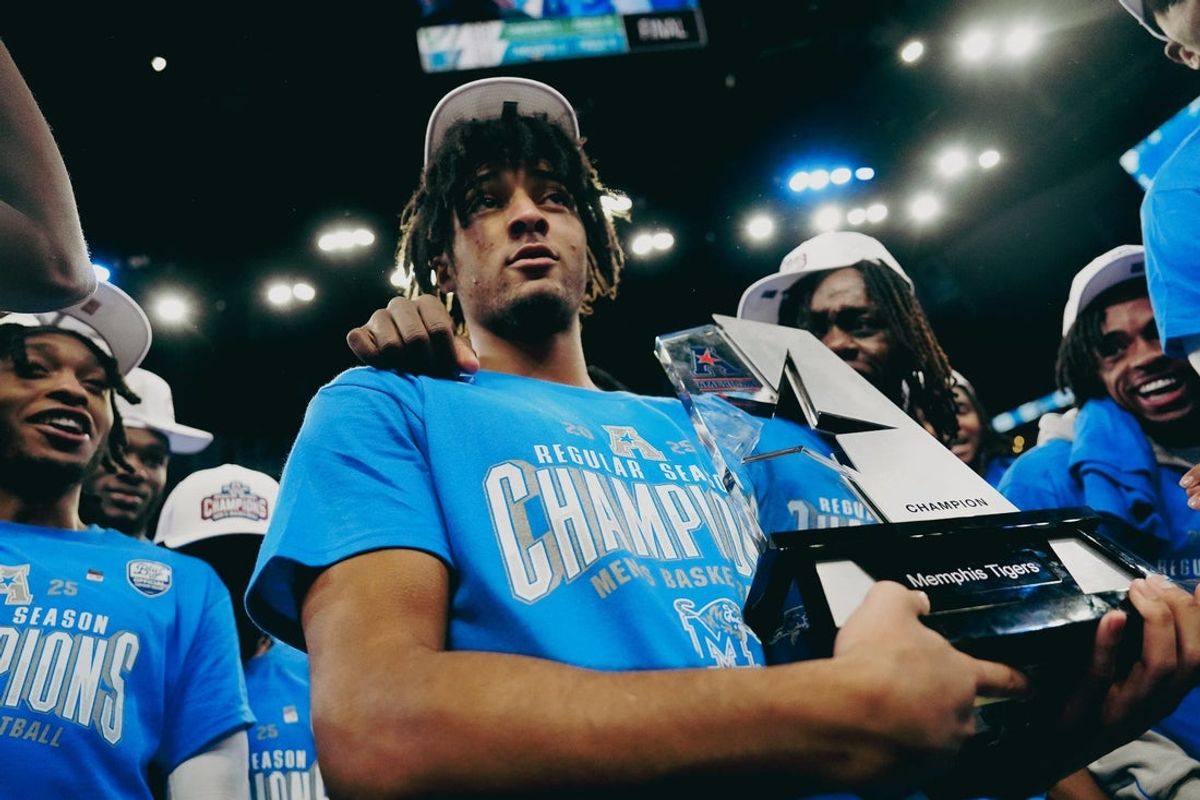 Memphis Tigers’ PJ Haggerty holds the AAC regular season champion trophy after securing a win against South Florida on Friday, March 7, 2025 at the FedEx Forum in Memphis, Tenn.