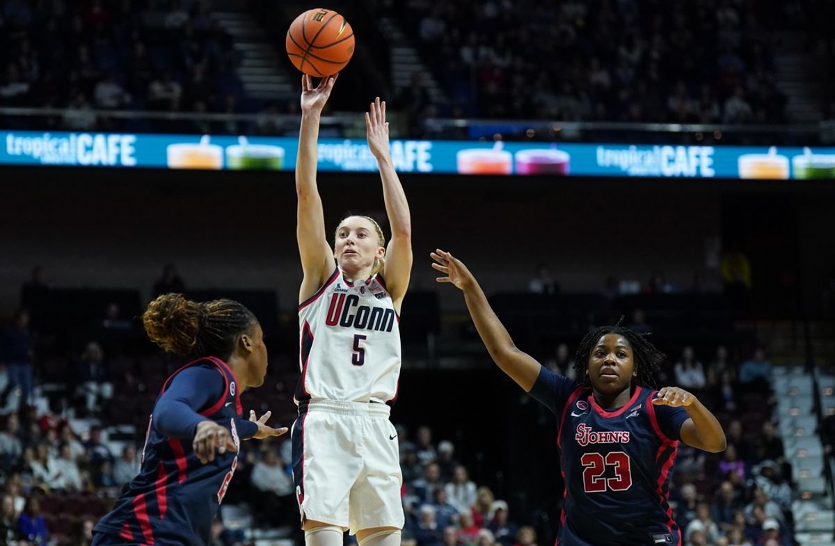Mar 8, 2025; Uncasville, CT, USA; UConn Huskies guard Paige Bueckers (5) shoots the ball against St. John's Red Storm guard Ber'Nyah Mayo (23) in the first half at Mohegan Sun Arena. Mandatory Credit: David Butler II-Imagn Images