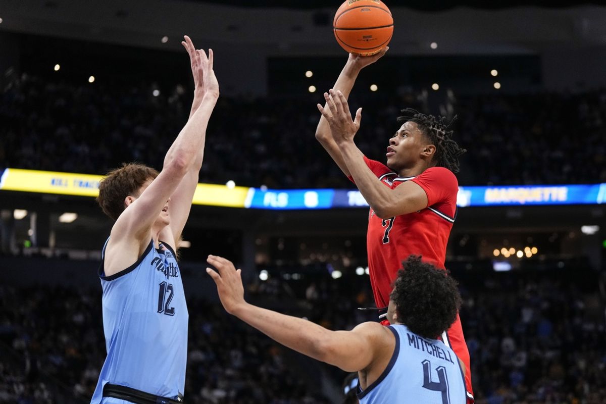 Mar 8, 2025; Milwaukee, Wisconsin, USA;  St. John's Red Storm guard Simeon Wilcher (7) shoots against Marquette Golden Eagles forward Ben Gold (12) during the first half at  Fiserv Forum. Mandatory Credit: Jeff Hanisch-Imagn Images