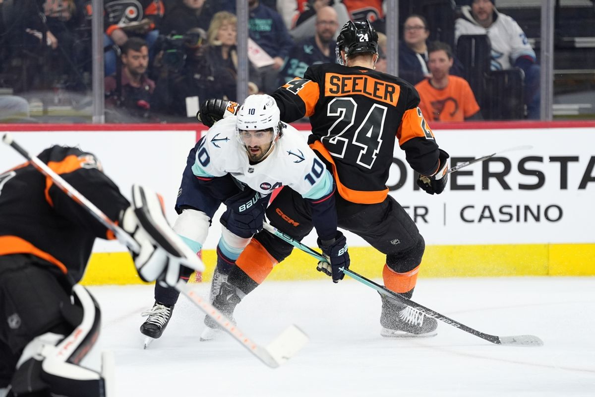 Mar 8, 2025; Philadelphia, Pennsylvania, USA; Seattle Kraken center Matty Beniers (10) collides with Philadelphia Flyers defenseman Nick Seeler (24) in the first period at Wells Fargo Center. Mandatory Credit: Kyle Ross-Imagn Images