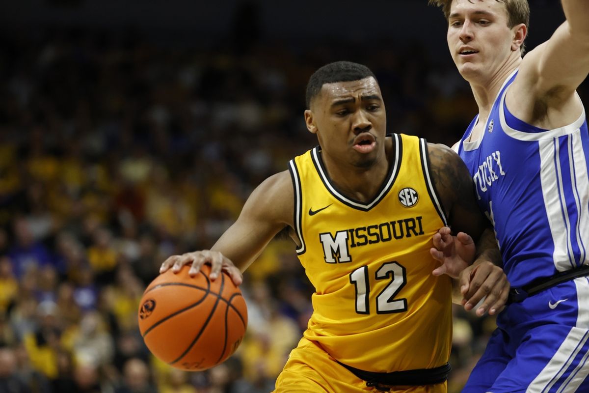 Mar 8, 2025; Columbia, Missouri, USA; Missouri Tigers guard Tony Perkins (12) drives to the basket against the Kentucky Wildcats during the first half at Mizzou Arena. Mandatory Credit: Gary Rohman-Imagn Images