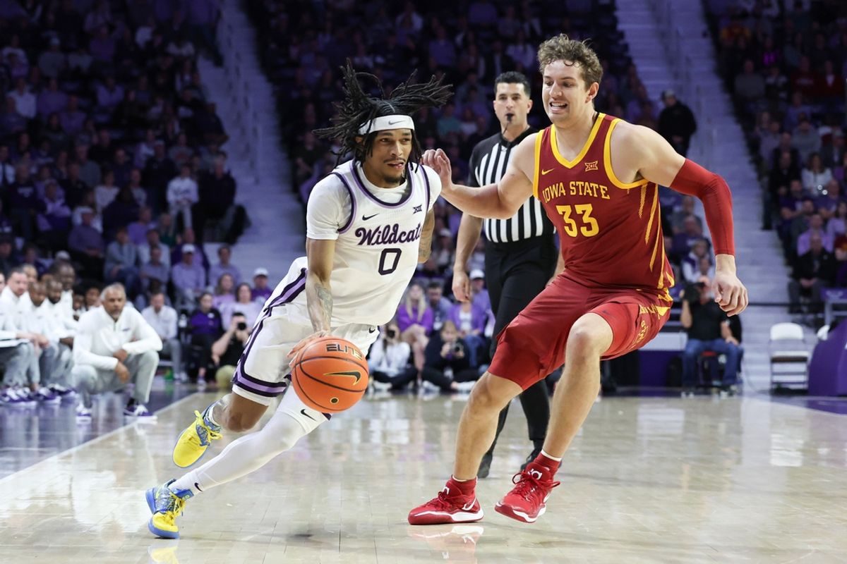Mar 8, 2025; Manhattan, Kansas, USA; Kansas State Wildcats guard Dug McDaniel (0) dribbles by Iowa State Cyclones forward Brandton Chatfield (33) during the first half at Bramlage Coliseum. Mandatory Credit: Scott Sewell-Imagn Images