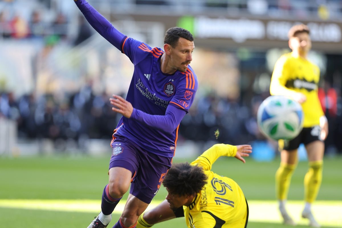 Mar 8, 2025; Columbus, Ohio, USA; Houston Dynamo defender Daniel Steres (5) heads the ball in front of Columbus Crew forward Jacen Russell-Rowe (19) during the first half at Lower.com Field. Mandatory Credit: Joseph Maiorana-Imagn Images