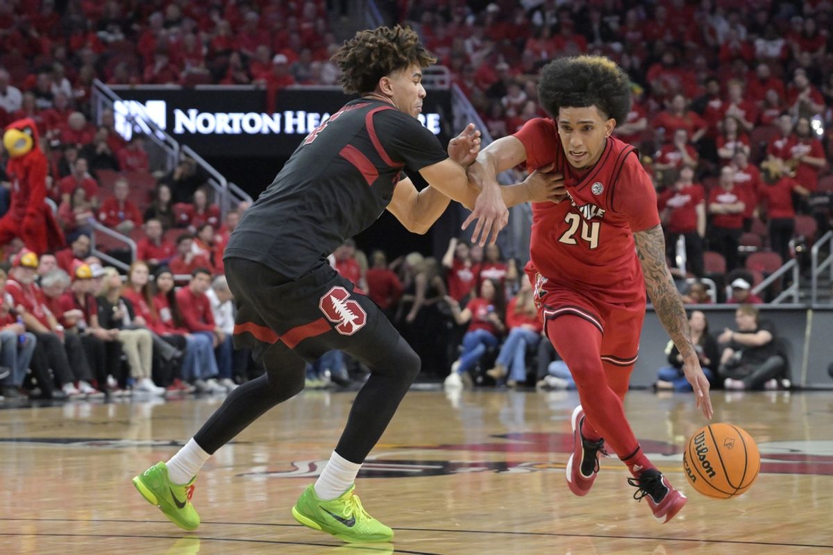 Mar 8, 2025; Louisville, Kentucky, USA;  Louisville Cardinals guard Chucky Hepburn (24) dribbles against Stanford Cardinal guard Oziyah Sellers (4) during the second half at KFC Yum! Center. Louisville defeated Stanford 68-48. Mandatory Credit: Jamie Rhodes-Imagn Images