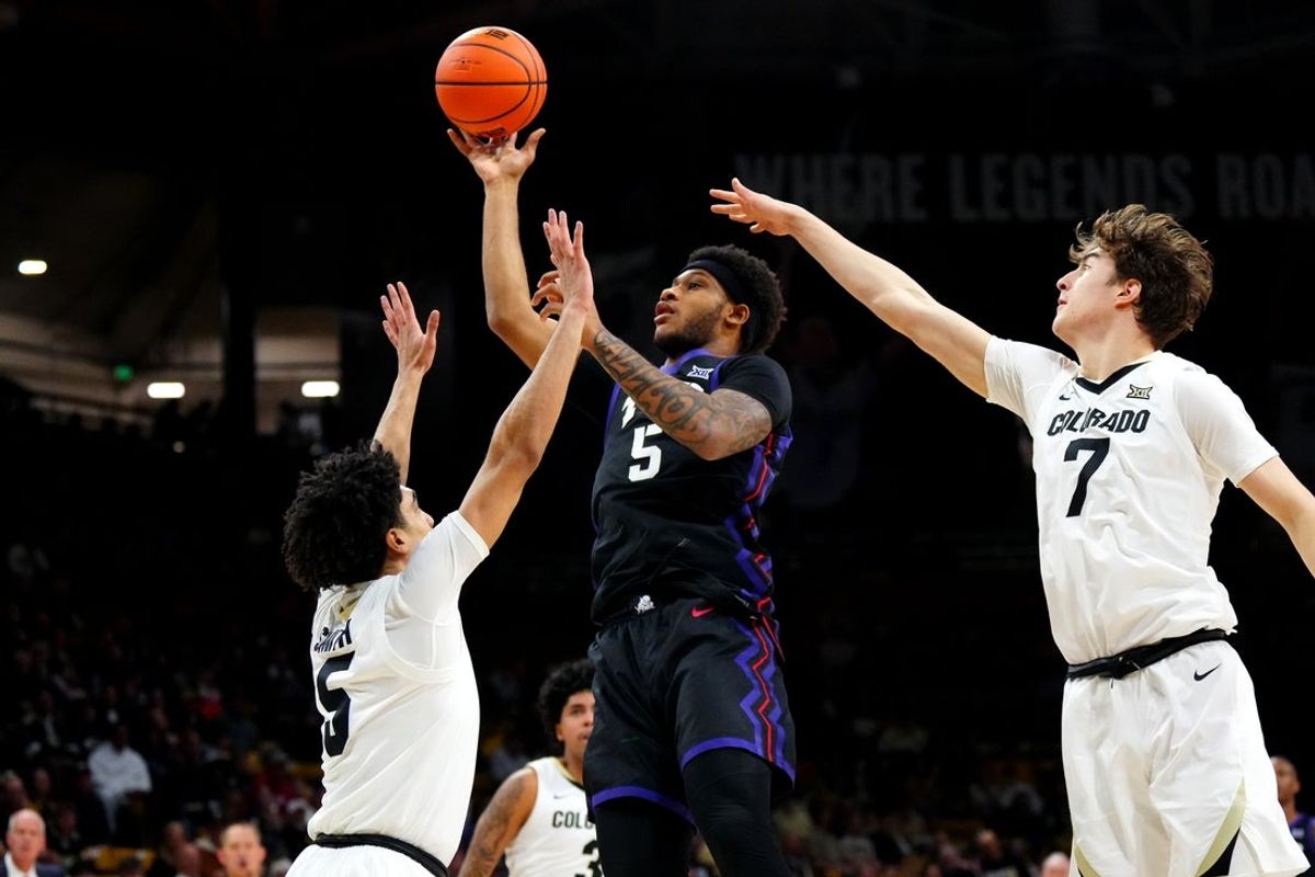 Mar 8, 2025; Boulder, Colorado, USA; TCU Horned Frogs forward Micah Robinson (5) shoots the ball over Colorado Buffaloes guard RJ Smith (5) and forward Sebastian Rancik (7) in the first half at the CU Events Center. Mandatory Credit: Ron Chenoy-Imagn Images