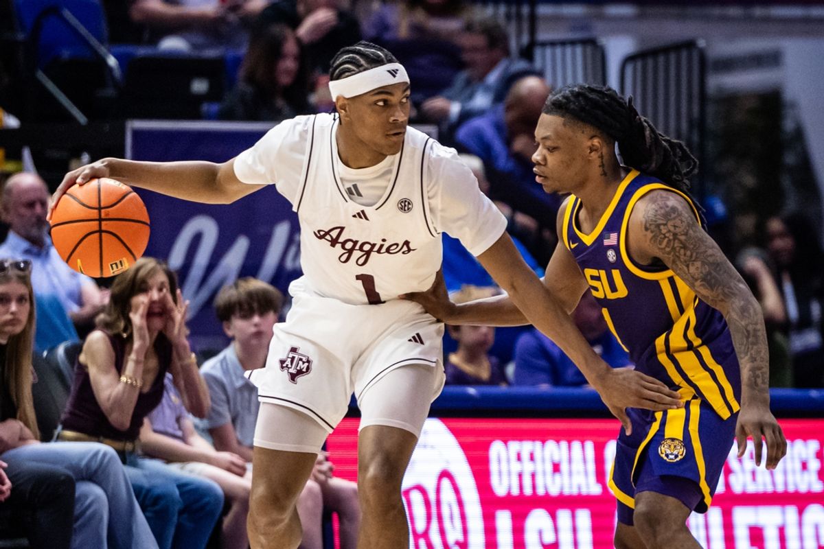 Mar 8, 2025; Baton Rouge, Louisiana, USA;  Texas A&M Aggies guard Zhuric Phelps (1) dribbles against LSU Tigers guard Jordan Sears (1) during the first half at Pete Maravich Assembly Center. Mandatory Credit: Stephen Lew-Imagn Images