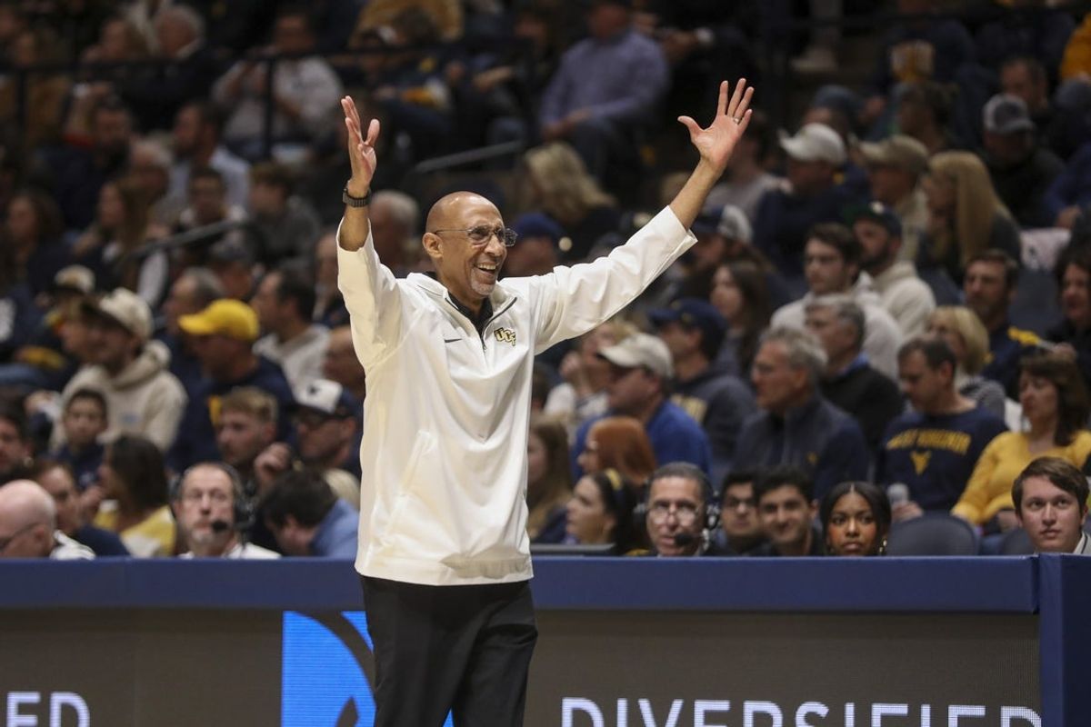 Mar 8, 2025; Morgantown, West Virginia, USA; UCF Knights head coach Johnny Dawkins argues a call during the first half against the West Virginia Mountaineers at WVU Coliseum. Mandatory Credit: Ben Queen-Imagn Images