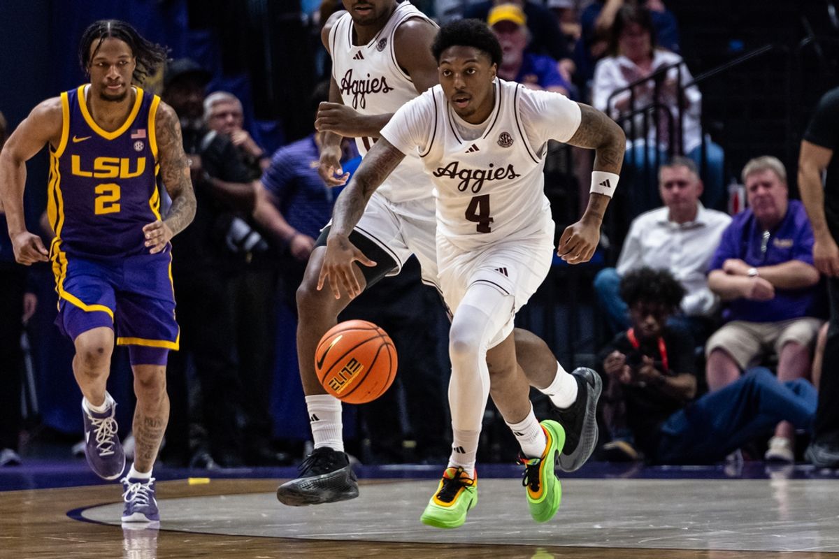 Mar 8, 2025; Baton Rouge, Louisiana, USA;  Texas A&M Aggies guard Wade Taylor IV (4) brings the ball up court against LSU Tigers guard Mike Williams III (2) during the second half at Pete Maravich Assembly Center. Mandatory Credit: Stephen Lew-Imagn Images