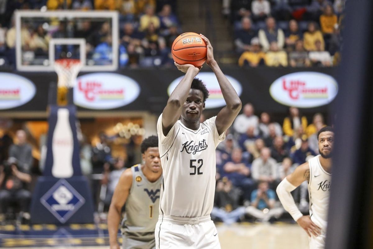 Mar 8, 2025; Morgantown, West Virginia, USA; UCF Knights center Moustapha Thiam (52) shoots a free throw during the second half .a2. at WVU Coliseum. Mandatory Credit: Ben Queen-Imagn Images